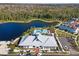 An aerial view of a community clubhouse, pool, surrounding homes, and a lake provides a picturesque setting at 2331 Celebration Blvd, Celebration, FL 34747