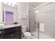 Bathroom features a glass enclosed shower, dark cabinetry and granite countertops at 2402 Dubai St, Kissimmee, FL 34747