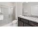 Bright bathroom with a glass-enclosed shower, granite counters, and a modern sink at 2402 Dubai St, Kissimmee, FL 34747