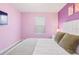 Cozy bedroom featuring pastel colors, plush pillows and a comfortable mattress, perfect for relaxation at 2402 Dubai St, Kissimmee, FL 34747