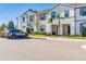 Townhome exterior showcasing well-maintained landscaping and a dedicated parking area for residents at 2402 Dubai St, Kissimmee, FL 34747