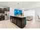 Open kitchen view showcasing an island with sink, stainless steel appliances, and adjacent living area at 2402 Dubai St, Kissimmee, FL 34747