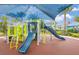 Community playground featuring a large sunshade structure, slides, and climbing elements at 2402 Dubai St, Kissimmee, FL 34747