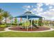 Community playground featuring a large sunshade structure, slides, and colorful play equipment at 2402 Dubai St, Kissimmee, FL 34747