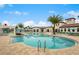 Beautiful community pool surrounded by lounge chairs and lush landscaping under a sunny sky at 2402 Dubai St, Kissimmee, FL 34747