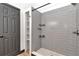 Updated walk-in shower features gray subway tile and built-in shelving at 2447 Ne 7Th St, Ocala, FL 34470