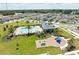 A stunning aerial view features a community pool, playground, and well-maintained homes in a neighborhood at 2715 Rowan St, Tavares, FL 32778