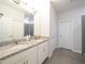 Bathroom featuring a double vanity with granite countertops and modern fixtures at 2715 Rowan St, Tavares, FL 32778