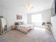 Bright bedroom featuring a ceiling fan, carpet, and a window for natural light at 2715 Rowan St, Tavares, FL 32778