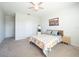 Spacious bedroom with a ceiling fan, carpet, and a window for natural light at 2715 Rowan St, Tavares, FL 32778