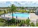 A refreshing community pool offers a relaxing oasis with lounge chairs and swaying palm trees at 2715 Rowan St, Tavares, FL 32778