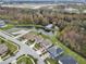 Aerial view highlighting home with solar panels and a nearby pond in a residential neighborhood at 2926 Boating Blvd, Kissimmee, FL 34746