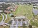 Aerial view of a community featuring a golf course, clubhouse, and tennis courts at 2926 Boating Blvd, Kissimmee, FL 34746