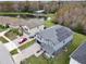 Aerial view of the home with solar panels, overlooking a pond and wooded area at 2926 Boating Blvd, Kissimmee, FL 34746