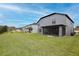 Expansive backyard showing the screened patio and the home's exterior at 2926 Boating Blvd, Kissimmee, FL 34746