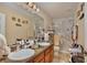 Bathroom showcasing dual sinks, granite countertops, and a glass-enclosed shower with marble walls at 2926 Boating Blvd, Kissimmee, FL 34746