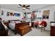 Bedroom featuring a queen bed, ceiling fan, and gallery wall of framed photos and art at 2926 Boating Blvd, Kissimmee, FL 34746