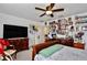 Cozy bedroom featuring a queen bed, dark wood furnishings, and a gallery wall of Gathering photos at 2926 Boating Blvd, Kissimmee, FL 34746