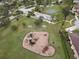 Aerial view of a neighborhood playground with slides and climbing structures in a lush, green park setting at 2926 Boating Blvd, Kissimmee, FL 34746