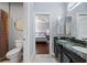 This bathroom features a toilet, a tile floor, and a dark wood vanity with a granite countertop at 3123 Bentonshire Pl, Longwood, FL 32779