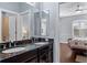 This bathroom includes a dark wood vanity, a granite countertop, and dual sinks at 3123 Bentonshire Pl, Longwood, FL 32779