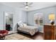 This bedroom features hardwood floors, a neutral paint color, and an ensuite bathroom at 3123 Bentonshire Pl, Longwood, FL 32779