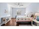 This bedroom features an arched window, neutral paint, hardwood floors, and a door at 3123 Bentonshire Pl, Longwood, FL 32779