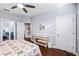 This bedroom features hardwood floors, a wooden console, and an ensuite bathroom at 3123 Bentonshire Pl, Longwood, FL 32779