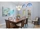 Bright dining room featuring stylish chandelier, artwork and French doors at 3123 Bentonshire Pl, Longwood, FL 32779