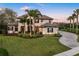 Grand exterior of the home with a well-manicured lawn, mature trees, and paved driveway at 3123 Bentonshire Pl, Longwood, FL 32779