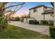 Expansive brick driveway leading to a three-car garage and lush landscaping at 3123 Bentonshire Pl, Longwood, FL 32779