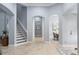 Bright foyer with staircase, arched doorways, and neutral tile flooring welcomes you home at 3123 Bentonshire Pl, Longwood, FL 32779