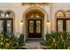 Elegant front entrance boasting double doors, arched details and manicured landscaping at 3123 Bentonshire Pl, Longwood, FL 32779