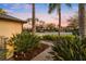 Landscaped front walkway with lush tropical foliage leading to a beautiful home at 3123 Bentonshire Pl, Longwood, FL 32779