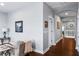 Bright hallway with hardwood floors and white trim, leading to various rooms in the house at 3123 Bentonshire Pl, Longwood, FL 32779