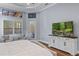 Well-lit main bedroom with large windows offering lots of natural light, hardwood floors, and a TV at 3123 Bentonshire Pl, Longwood, FL 32779