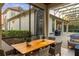 Covered outdoor dining area with wood table, wicker chairs, and views of the pool and backyard at 3123 Bentonshire Pl, Longwood, FL 32779