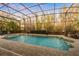 Inviting pool area with a spa, lush landscaping, and a screened enclosure for year-round enjoyment at 3123 Bentonshire Pl, Longwood, FL 32779