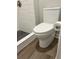 Modern white toilet in bathroom with updated flooring and shower at 3224 Holland Dr, Orlando, FL 32825