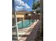 Side view of private pool with safety fence and brick pavers at 3224 Holland Dr, Orlando, FL 32825