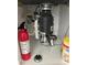 Shot of the under-sink area showcasing the garbage disposal and plumbing at 3224 Holland Dr, Orlando, FL 32825