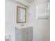 Bathroom vanity with a gray cabinet, white sink, and framed mirror at 34936 3Rd Ave, Leesburg, FL 34788