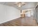 Bright living room with laminate flooring open to kitchen, ceiling fan and natural light at 34936 3Rd Ave, Leesburg, FL 34788