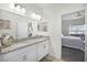 Elegant bathroom featuring granite countertops, double vanity, and natural lighting at 3543 Fairwaters Ct # D, Clermont, FL 34711