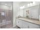 Elegant bathroom featuring granite countertops, a glass enclosed shower, and modern fixtures at 3543 Fairwaters Ct # D, Clermont, FL 34711