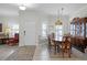 Traditional dining room showcasing a wood table, china cabinet, and natural lighting at 3543 Fairwaters Ct # D, Clermont, FL 34711