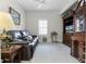 Comfortable living room with a leather sofa, natural light, and light colored carpet at 3543 Fairwaters Ct # D, Clermont, FL 34711