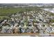 An aerial view shows a well-maintained suburban neighborhood with tree-lined streets and manicured lawns at 398 Lake Amberleigh Dr, Winter Garden, FL 34787