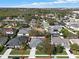 Aerial shot of a charming neighborhood with a serene pond, mature trees, and manicured lawns, with a home highlighted in red at 398 Lake Amberleigh Dr, Winter Garden, FL 34787