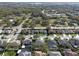 An aerial view showcases a neighborhood with manicured lawns and a community pool nestled among mature trees at 398 Lake Amberleigh Dr, Winter Garden, FL 34787